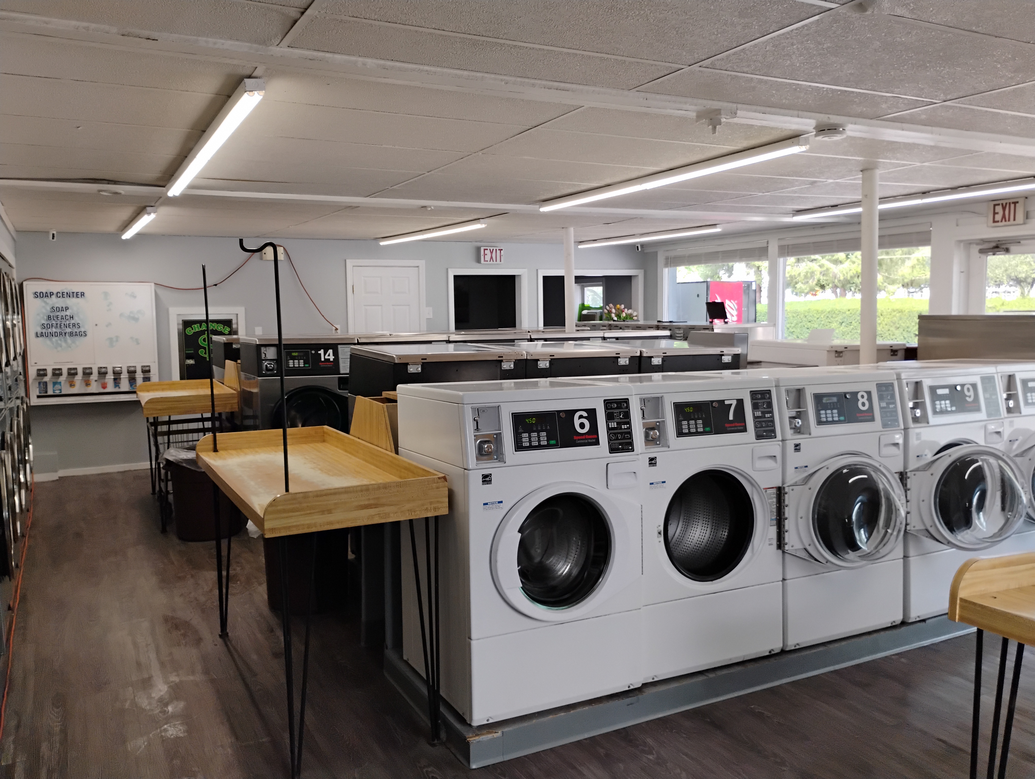 Bright interior and folding tables at Monument Laundromat