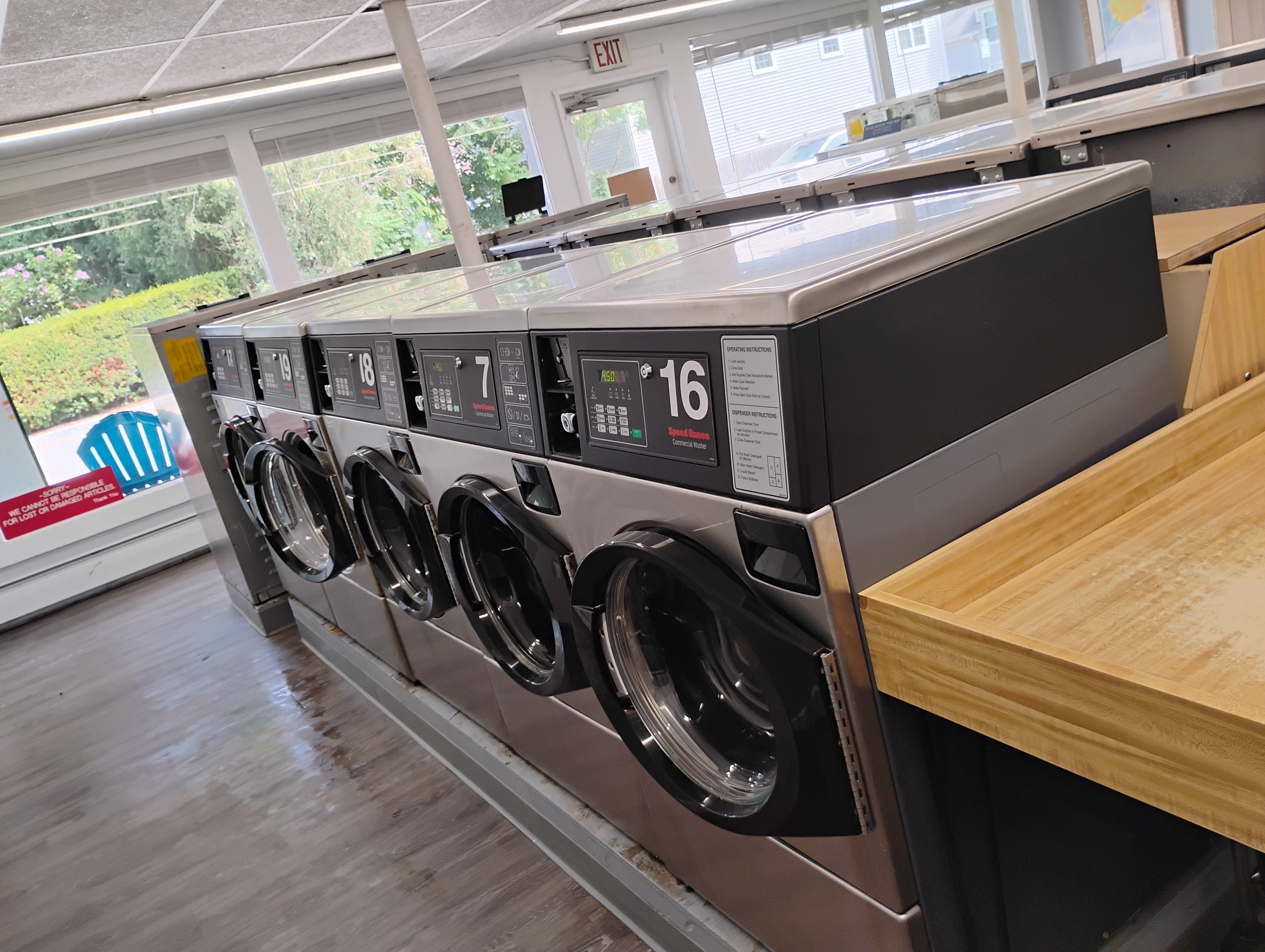 Rows of commercial washers and folding tables